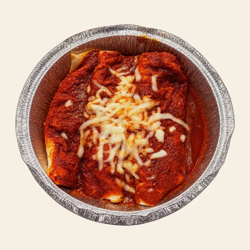 Enchiladas rojas with red sauce and cheese in a foil tray