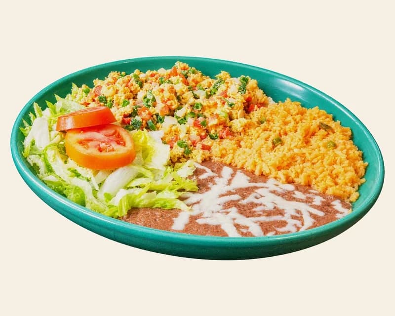 Huevos a la mexicana with rice, refried beans, lettuce and tomato